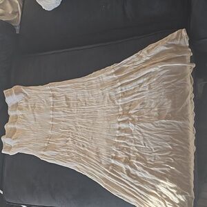 Long, flowy beige skirt